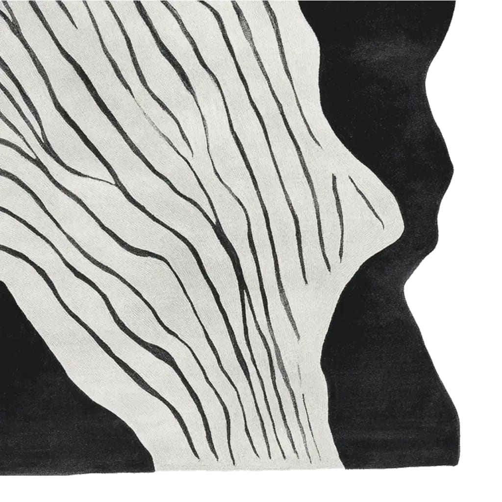 Close-up view of a Black White Rhythm Hand Tufted Area Rug featuring an abstract design with flowing black lines on a white background, perfect for contemporary living room decor. This wool rug adds a sophisticated touch to any space, ideal as a living room area rug.