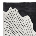 Close-up view of the Black White Rhythm Hand Tufted Area Rug, showcasing its contemporary abstract design with flowing black lines on a white background. Perfect for adding a modern touch to living room area rugs, this wool rug offers both style and comfort.