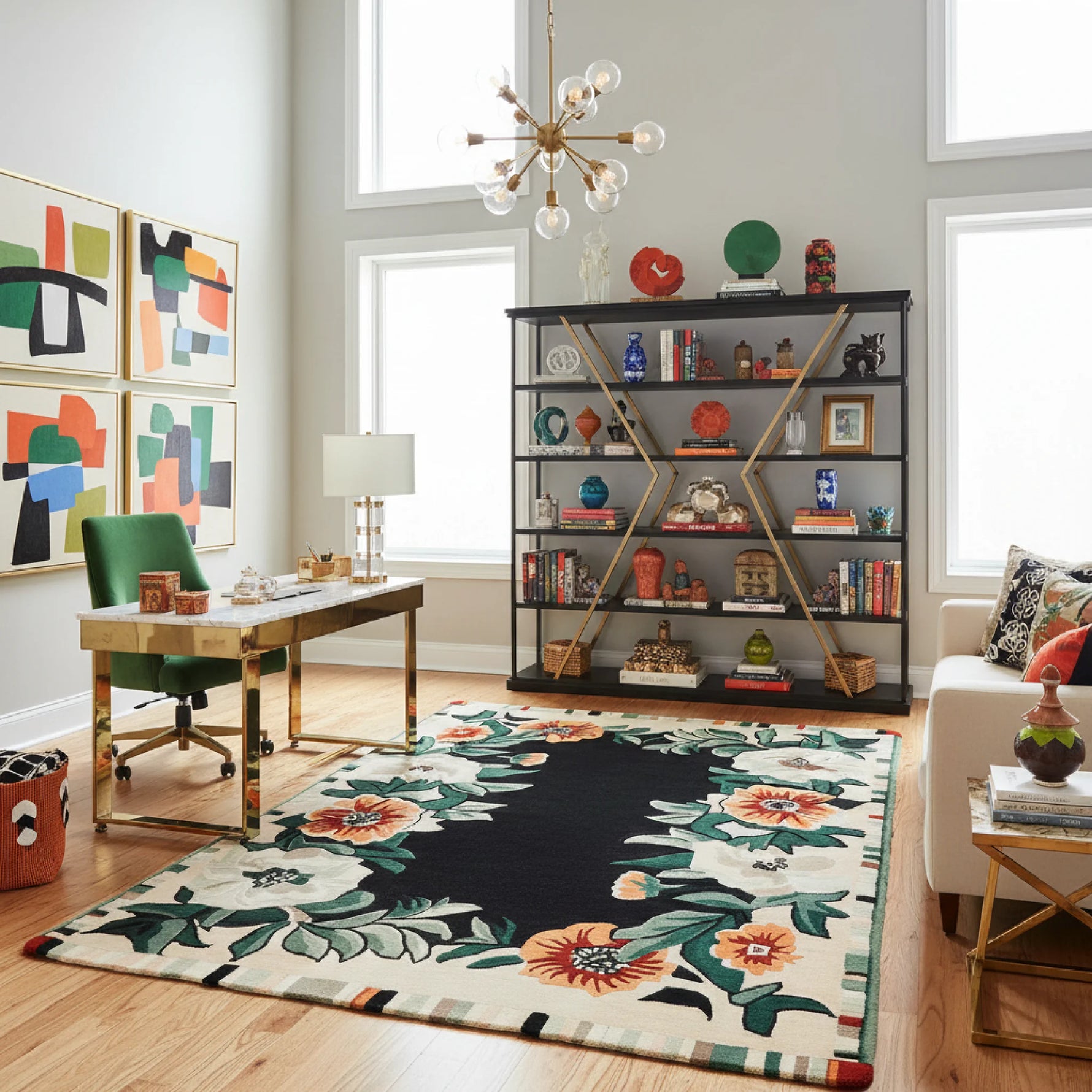 Modern office room with a floral rug, bookshelf, and artwork.
