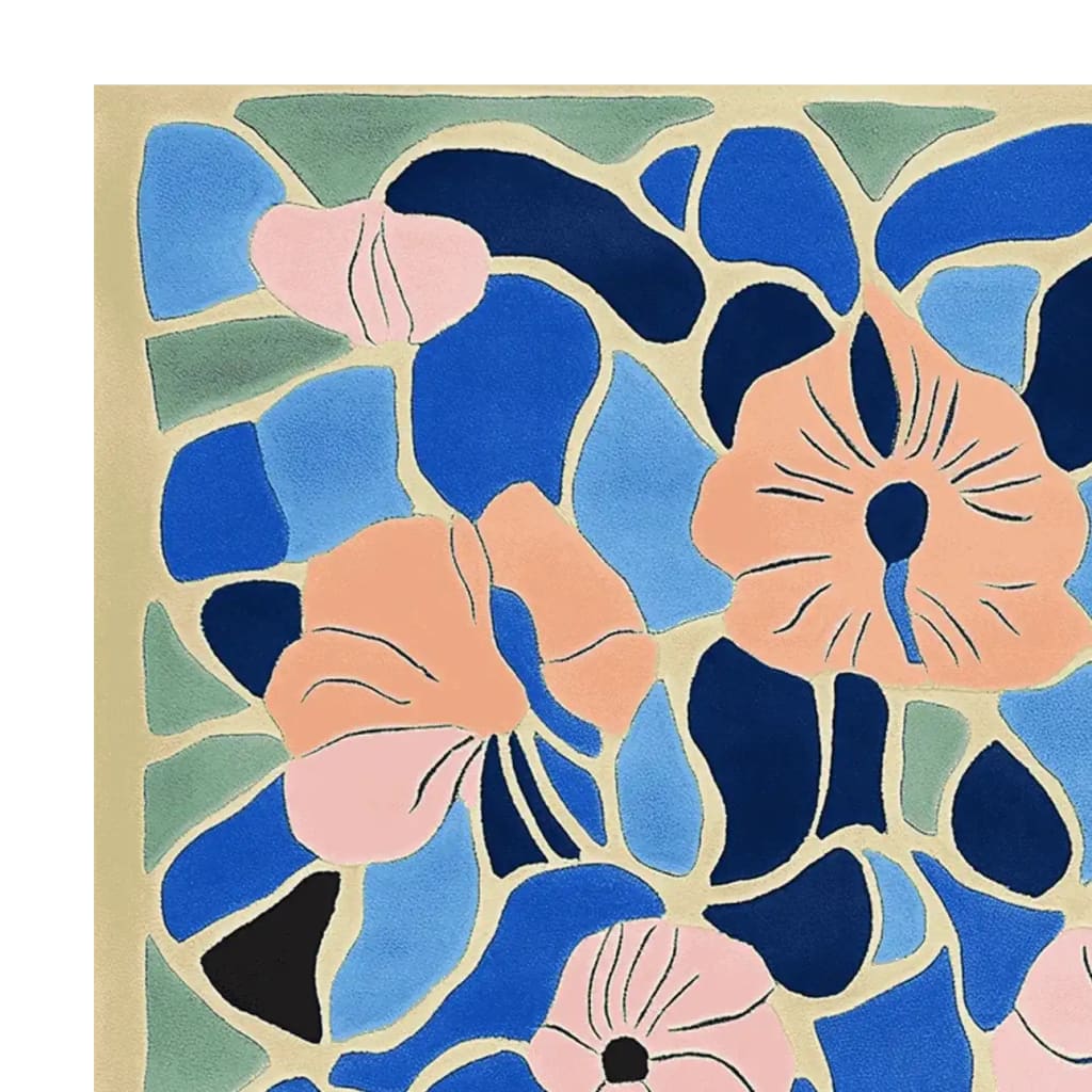A vibrant hand-tufted area rug featuring an abstract mosaic design with bold floral patterns in shades of blue, peach, and pink. The intricate blend of colors creates a lively and artistic centerpiece, perfect for adding a splash of creativity to any room.