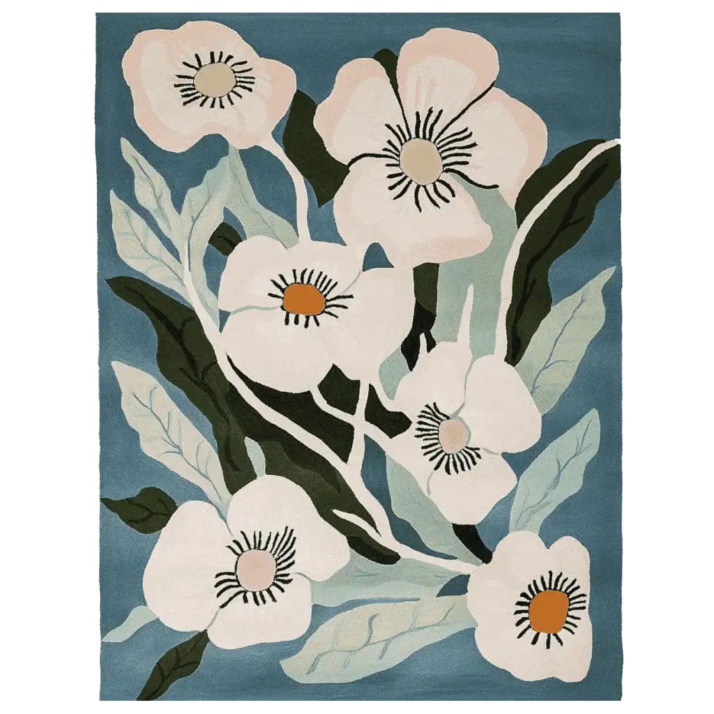 A vibrant Bloomcore Reverie Hand Tufted Rug featuring a floral design with large white blossoms and green leaves on a teal background. Perfect for adding a contemporary touch to any large living room, this wool area rug offers a stylish blend of nature-inspired aesthetics and comfort, ideal for those seeking rugs for living room spaces.