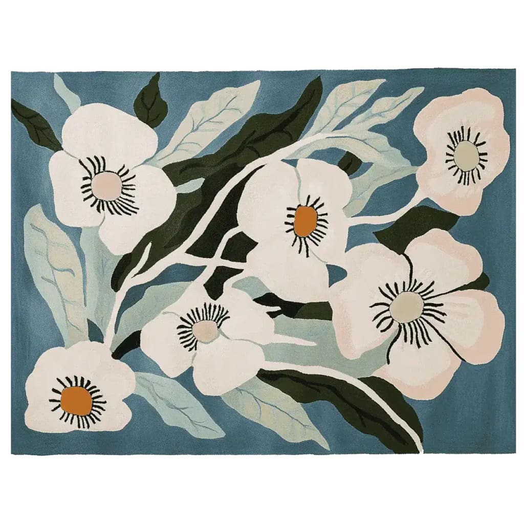 The Bloomcore Reverie Hand Tufted Rug features a stunning floral design with large white flowers and green leaves against a soft blue background. This contemporary wool area rug adds elegance to any large living room, making it perfect for those seeking stylish rugs for their living room.