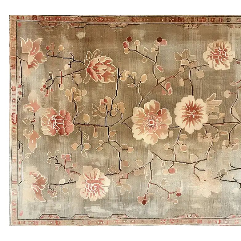 Top view of the Blooming Grace Knotted Wool Rug, showcasing an elegant floral design with soft pink and beige blossoms on a muted background. This area rug adds a touch of sophistication and warmth to any living space.