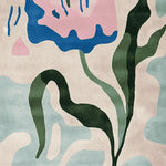 A vibrant hand-tufted area rug featuring an abstract floral design with flowing green leaves and bold pink and blue shapes. Perfect for contemporary living room decor, this wool rug adds a splash of color and style to any space. Ideal for those seeking modern 8x10 living room area rugs.