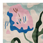 Close-up of the Blooming Shape Symphony Hand Tufted Rug showcasing an abstract floral design in pink, blue, and green hues. This contemporary wool area rug is perfect for adding a vibrant touch to any living room. Ideal for those seeking an 8x10 living room area rug.