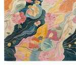 Vibrant area rug featuring an abstract floral design with swirling colors of pink, orange, blue, and yellow, creating a lively and artistic atmosphere.