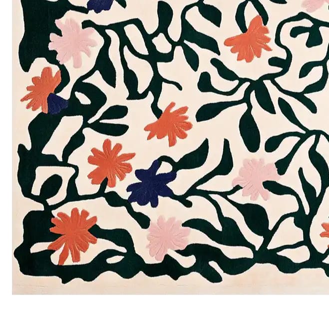 This vibrant area rug features a hand-tufted design with colorful blossoms and intricate green vines on a light backdrop, creating a lively and artistic pattern.