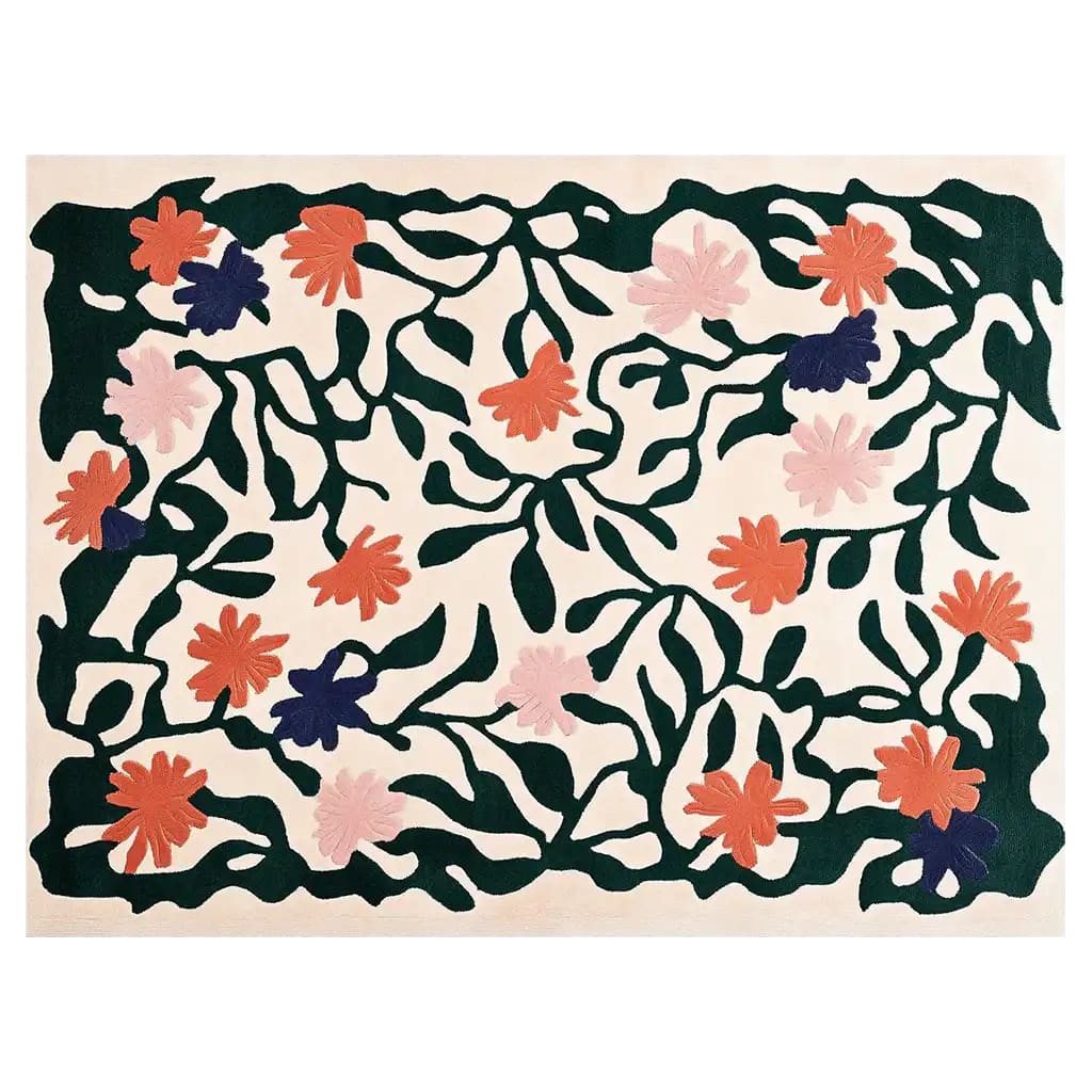 A vibrant hand-tufted wool area rug featuring a lively floral design with pink, orange, and dark green hues. The rug displays an intricate pattern of blossoming flowers and leaves, adding a touch of nature-inspired elegance to any room.