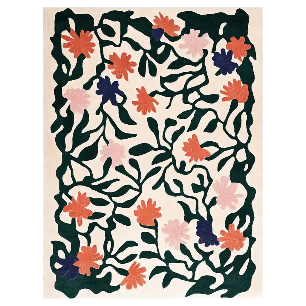 The Blossom Celestial Hand Tufted Wool Rug showcases a vibrant floral design with bold, abstract flowers in shades of orange, pink, and purple, surrounded by dark green vines. This area rug brings a touch of nature-inspired elegance to any room.