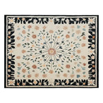 Top view of the Blossom Frame Hand Tufted Wool Area Rug, featuring an intricate floral pattern with a central blossom design surrounded by colorful leaves and flowers. The rug's border is adorned with a black background and floral motifs, creating a harmonious blend of elegance and warmth.