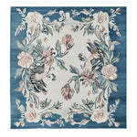 The Blossom Serenade Tapestry Hand Tufted Rug is a stunning square area rug perfect for adding elegance to your living room. This wool rug features a beautiful floral design with intricate blossoms and leaves in soft pink and green hues on a rich blue background. Ideal for those seeking rugs for living room spaces, this 8x10 square rug offers a luxurious touch and a cozy feel.