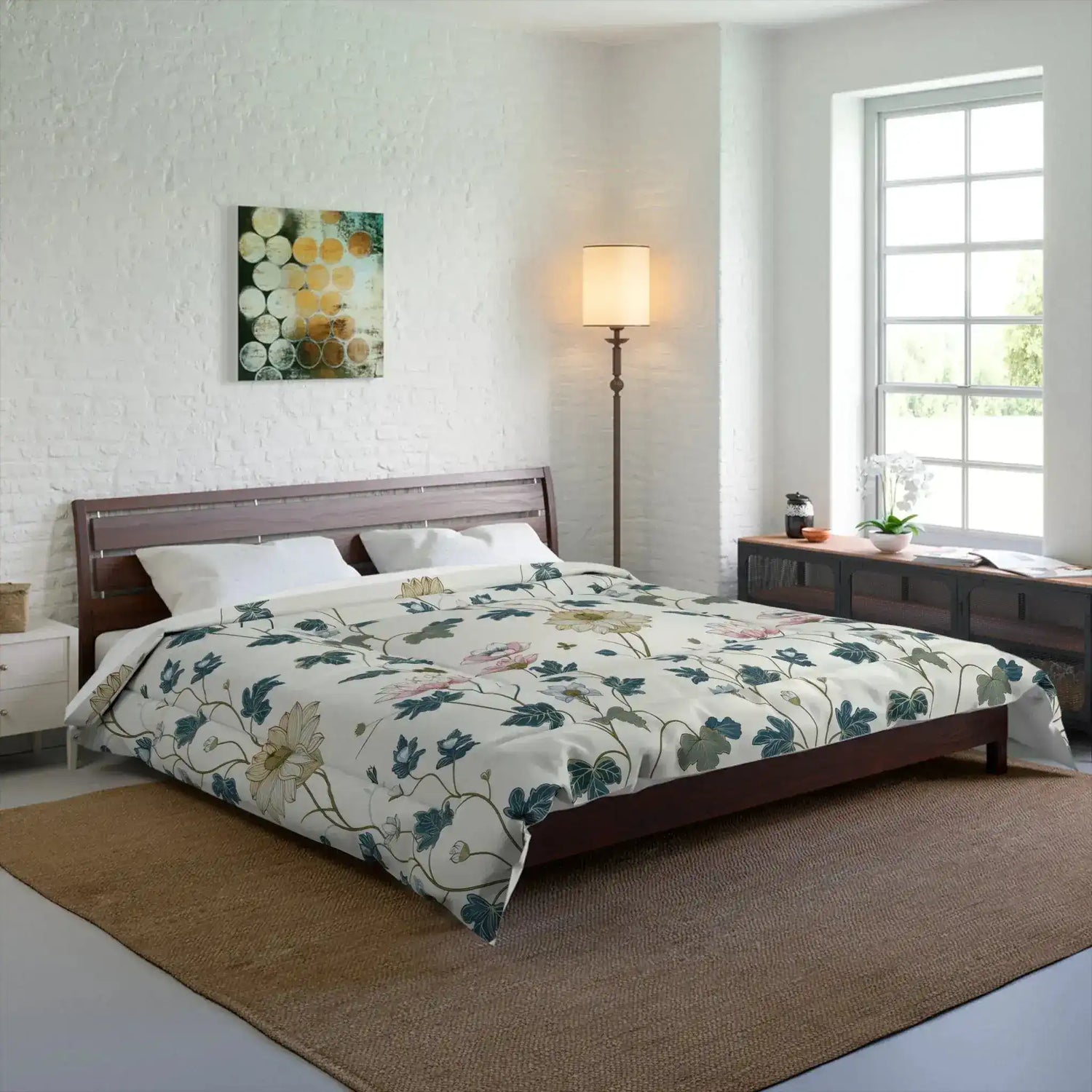 Cream floral comforter dressed on a wood bed in a bright white-brick bedroom