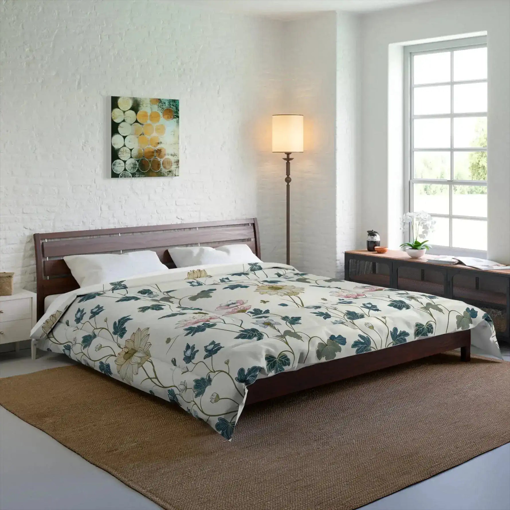 Cream floral comforter dressed on a wood bed in a bright white-brick bedroom