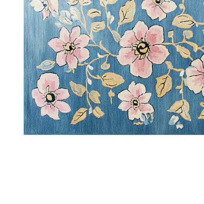 A beautifully designed area rug featuring a vibrant floral pattern with pink blossoms and golden leaves on a rich blue background. The Blossom Vine Tapestry Hand Tufted Wool Rug adds a touch of elegance and warmth to any room.