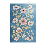 The Blossom Vine Tapestry Hand Tufted Wool Area Rug features an elegant floral design with pink blossoms and golden vines on a blue background, creating a vibrant and inviting look.