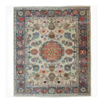 Vibrant Blossom Vista Hand Knotted Area Rug showcasing an intricate floral pattern with a central medallion design, surrounded by colorful flowers and ornate detailing. The rich colors and traditional motifs make this area rug a captivating centerpiece for any room.