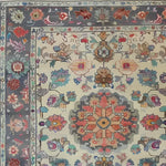 Close-up of the Blossom Vista Hand Knotted Area Rug showcasing its intricate floral patterns and vibrant colors, perfect for adding a touch of elegance to any living room. This vintage-inspired Persian rug features detailed blooms in a harmonious blend of hues, ideal for those seeking a stylish floral rug.