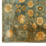 A close-up view of the Blossoming Elegance Hand Tufted Wool Rug showcasing intricate floral patterns in warm hues on a soft, muted background. This area rug adds a touch of elegance and sophistication to any room decor.