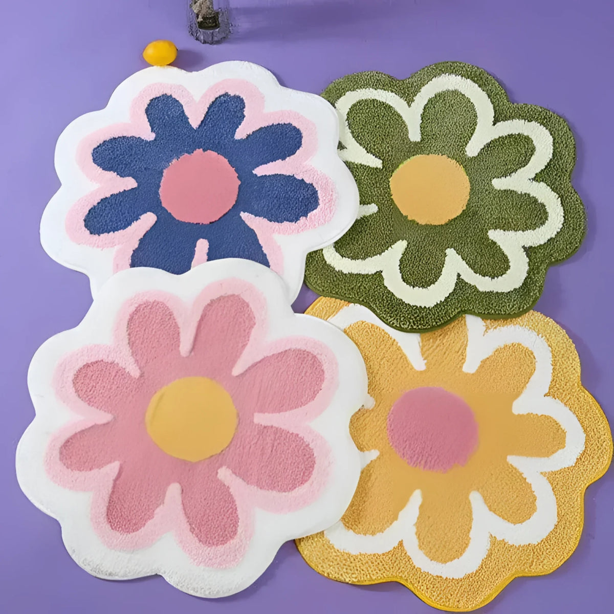 A colorful display of four flower-shaped area rugs on a purple background. Each rug features a unique color combination, with bold and vibrant petals surrounding a contrasting center, adding a playful and decorative touch to any room.