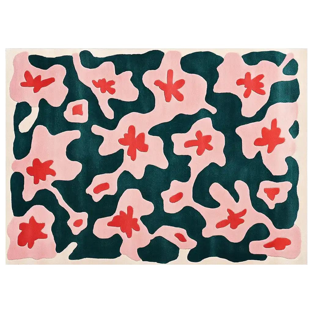 Vibrant area rug featuring a bold abstract design with pink and red floral patterns set against a deep teal background, adding a touch of artistic flair to any room.