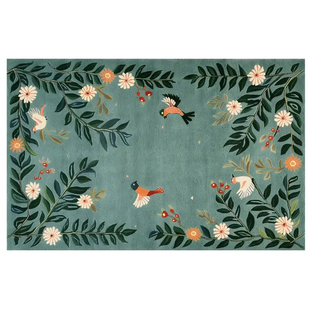 A vibrant area rug featuring a whimsical design of birds and flowers against a soft green background. The Blossoming Winged Haven Knotted Wool Rug showcases intricate floral patterns with colorful birds in flight, creating a lively and inviting atmosphere.