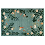 A vibrant area rug featuring a whimsical design of birds and flowers against a soft green background. The Blossoming Winged Haven Knotted Wool Rug showcases intricate floral patterns with colorful birds in flight, creating a lively and inviting atmosphere.
