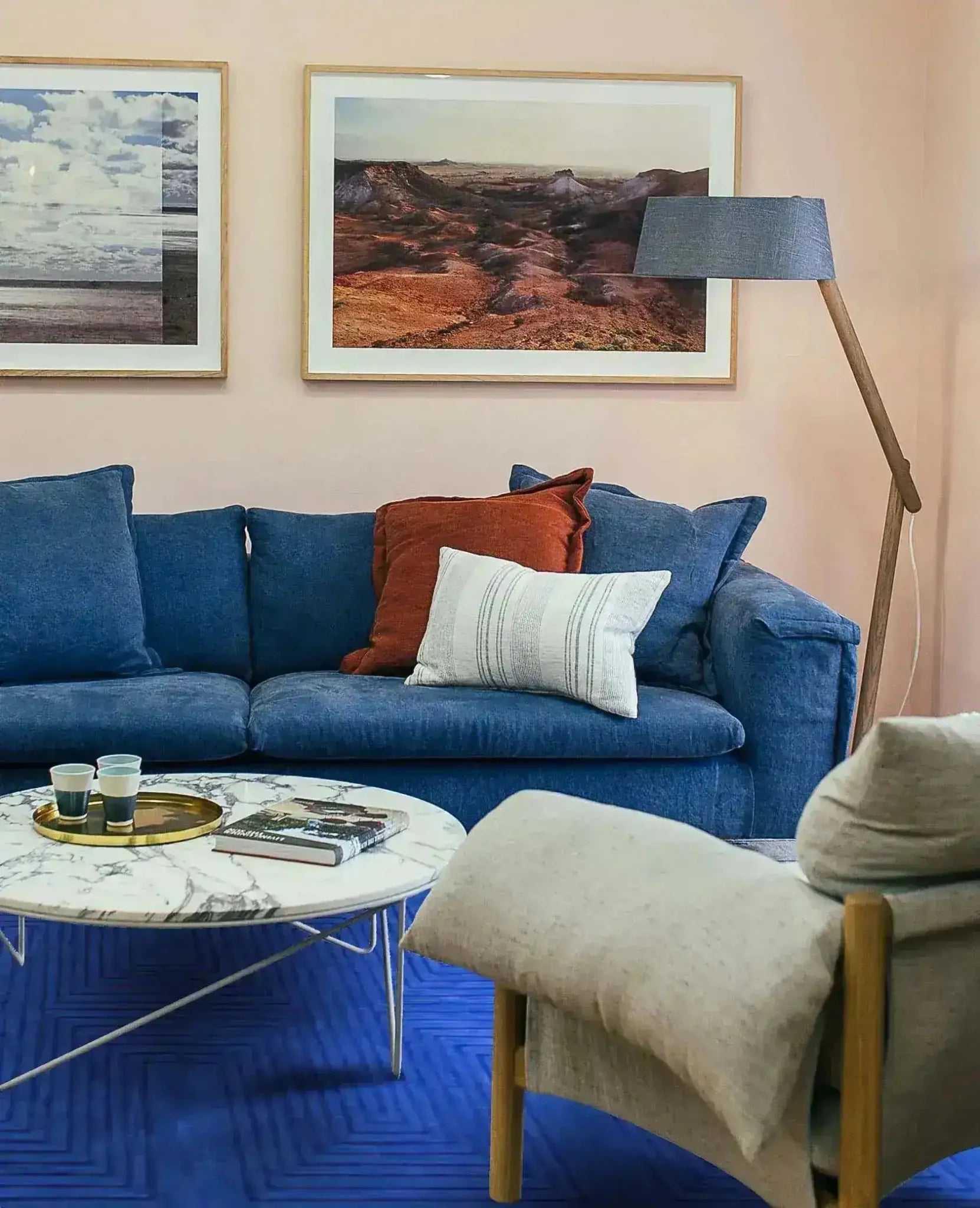 A stylish living room featuring a Blue Arctic Geo Modern Hand Tufted Wool Area Rug. The 8 x 10 ft rug adds a bold touch to the space, complementing the blue sofa and modern decor. Perfect for enhancing rugs for living rooms or dining room settings, this wool rug combines comfort and design seamlessly.