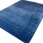 Top view of the Blue Arctic Geo Modern Hand Tufted Wool Rug, perfect for a living room or dining room. This luxurious 8 x 10 ft area rug features a geometric pattern that adds a contemporary touch to any space, making it an ideal choice for those seeking high-quality wool rugs for living room or dining room area rugs.