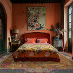 Elegant bedroom featuring a Blue Bordered Spring Floral in the Golden Sky Wool Hand Knotted Area Rug. The vibrant area rug complements the warm tones of the room, making it perfect for dining rooms or as a living room area rug. The intricate floral patterns add a touch of sophistication to the cozy space.