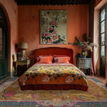 Elegant bedroom featuring a Blue Bordered Spring Floral in the Golden Sky Wool Hand Knotted Area Rug. The vibrant area rug complements the warm tones of the room, making it perfect for dining rooms or as a living room area rug. The intricate floral patterns add a touch of sophistication to the cozy space.