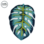 A beautifully crafted Blue Monstera Leaf Shaped Accent Hand Tufted Wool Rug measuring 2 x 3 ft. This elegant area rug, perfect for a bedroom or living room, features a striking design with vibrant blue and green hues. Ideal for those seeking stylish area rugs for living room or bedroom area rugs.