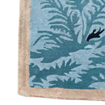 Close-up view of the Blue Peacock Floral Hand Tufted Area Rug, featuring intricate blue and beige patterns perfect for enhancing bedroom decor. Ideal for those seeking quality bedroom area rugs made from wool.