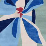 Top view of the Blue Petal Surg Hand Tufted Area Rug, showcasing its contemporary abstract design with shades of blue, white, and red. This wool square rug is perfect for enhancing the aesthetic of living room spaces, offering a stylish and vibrant addition to area rugs for living room decor.