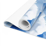 Rolled blue mountain-print yoga mat revealing the coiled cross-section and thickness