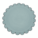 Round blue rug with scalloped edge on a white background