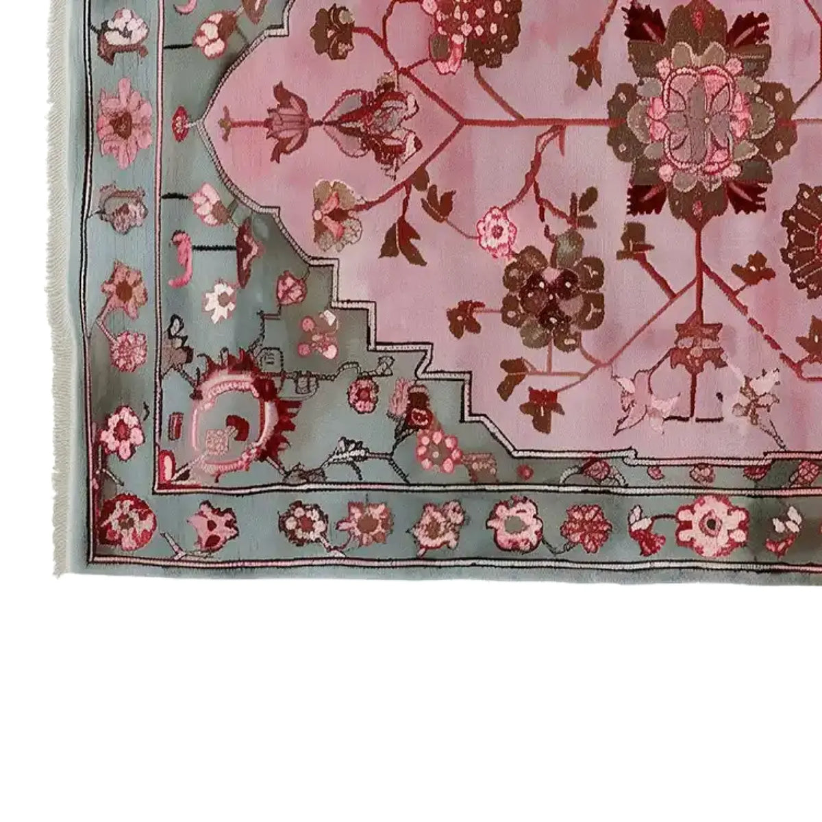 Close-up view of the Blush Medallion Knotted Wool Rug, showcasing intricate floral patterns in pink and brown tones on a soft blush background, framed by a detailed blue-green border with floral motifs.