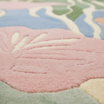 Close-up of a colorful children's rug with pastel shades.
