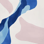 A close-up view of the Blush Wind Composition Hand Tufted Area Rug featuring an abstract design with soft pink and blue shapes. The elegant color palette adds a modern touch to any room decor.