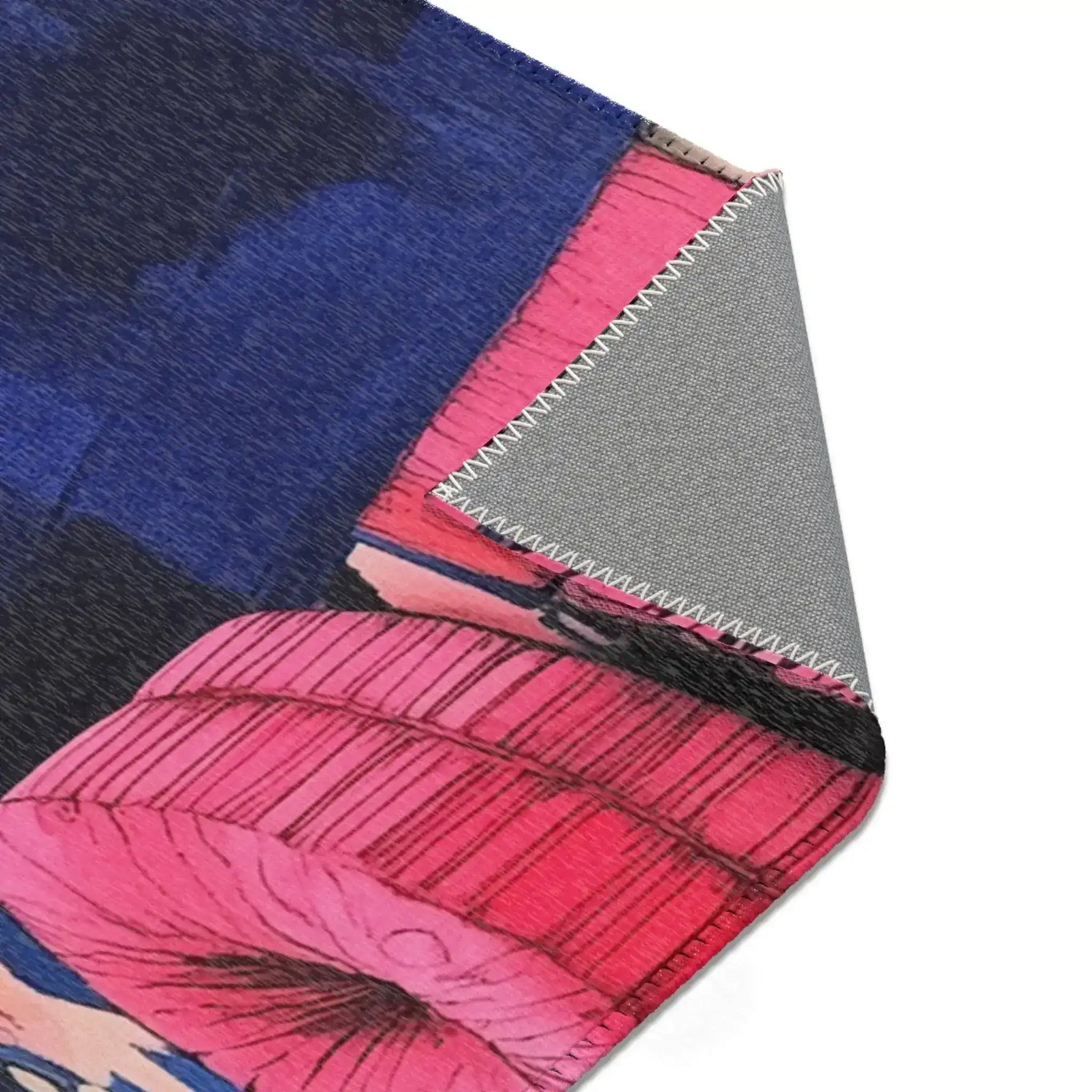Corner fold of Bold Blue Elegance Luxe Maximalist Rug showing cobalt blue pink printed face with grey anti-slip backing and zigzag edge