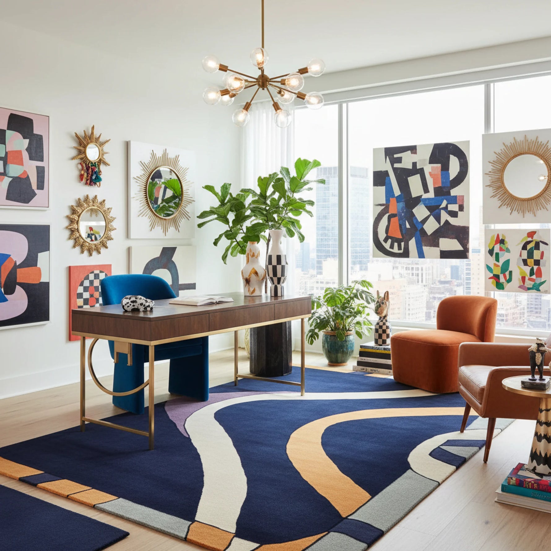 Modern living room with a desk, colorful rug, and abstract art.
