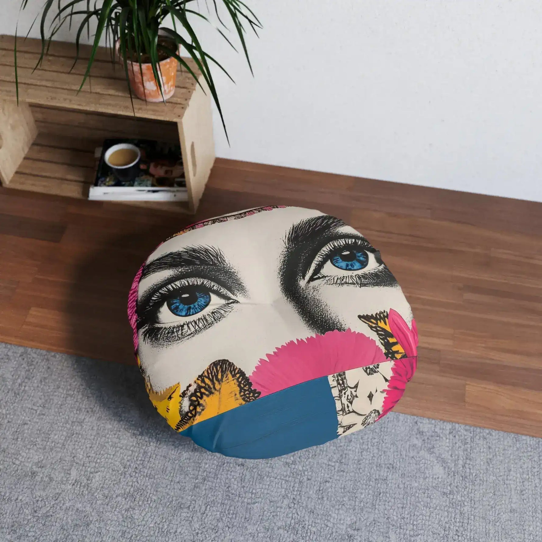 Bold Floral Portrait Floor Pillow styled in room on wood floor beside wooden shelf with plant, blue eyes collage face visible
