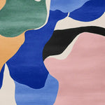 Vibrant abstract design of the Bold Shape Talk Bold Hand Tufted Area Rug featuring a mix of blue, pink, green, and orange colors. Ideal for adding a contemporary touch to living rooms, this wool rug enhances any space with its bold artistic patterns.