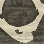 Close-up of the Bone Ring Ritual Hand Tufted Area Rug showcasing its contemporary abstract design. This wool rug features bold black and beige patterns, perfect for enhancing living room area rugs with a modern touch.