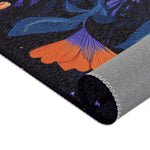 Botanical Bliss Floral Design Accent Rug corner fold showing orange ginkgo bloom and blue-purple leafy botanical pattern, grey backing