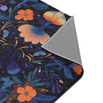 Botanical Bliss rug rolled corner close-up showing blue swirling background with warm orange and yellow tones, grey backing tube