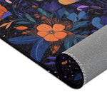Botanical Bliss Floral Design Accent Rug rolled edge showing orange flower and blue-purple botanical foliage on dark ground