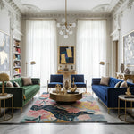 Luxurious living room with blue and green sofas, gold coffee table, a contemporary wool rug, and decorative elements.
