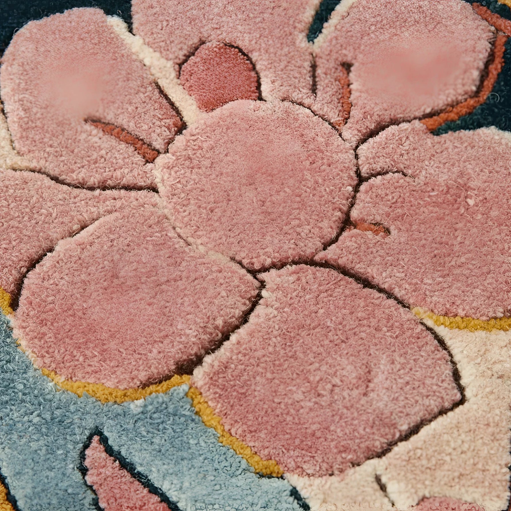 Close-up of a textured pink flower design on a rug.