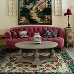 Elegant living room showcasing a Botanical Bliss Medium Hand Knotted Wool Rug, perfect for adding a touch of sophistication to any space. This large area rug features intricate floral patterns, ideal for those seeking Persian rug style in an 8x10 size. The wool rug beautifully complements the plush pink sofa and rustic wooden table, making it a stunning centerpiece for large living rooms.