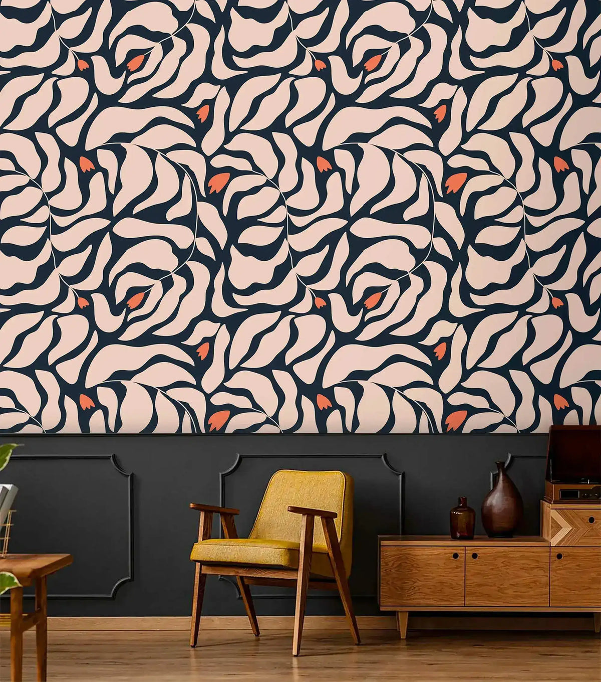Botanical extravaganza wallpaper above dark navy paneling; retro yellow armchair and mid-century teak sideboard below